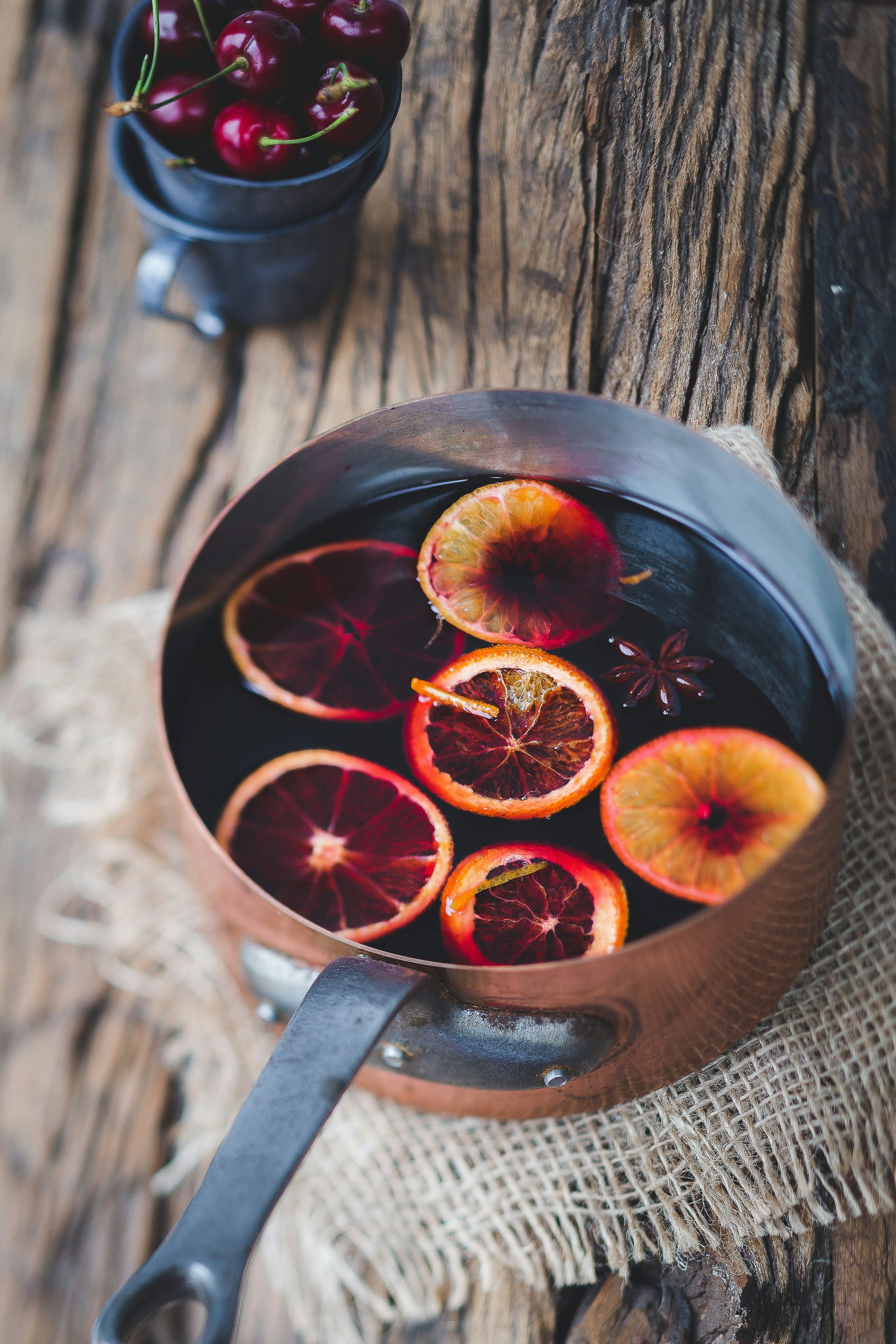 Metal pot full of orange slices for Christmas table decor. Vintage dishes from estate sales finds for Christmas decor ideas