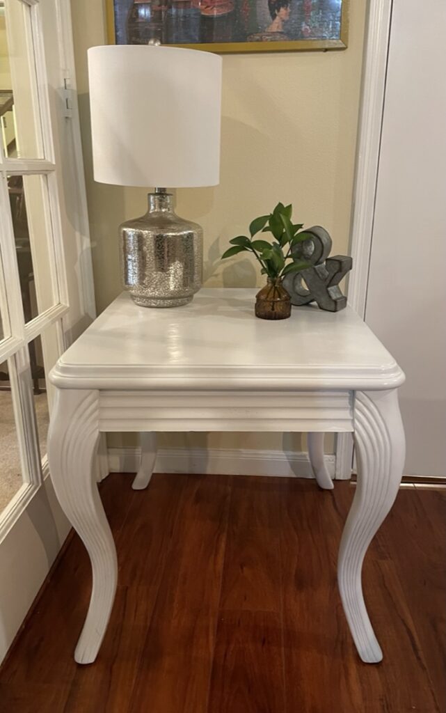 White table that is one of the quick  and easy furniture makeovers to improve profits. It was a dated brown table and now painted white.